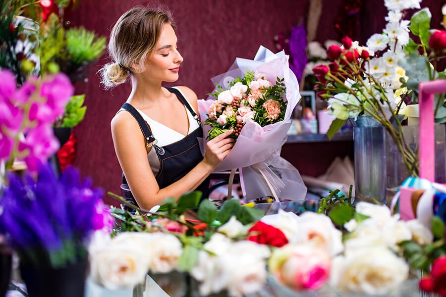 florist-woman-creates-flower-bouquet-of-mixed-flow