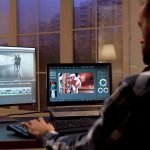 Back view of content creator working in home office