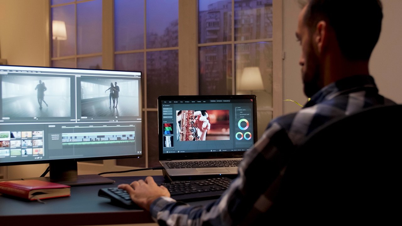 Back view of content creator working in home office