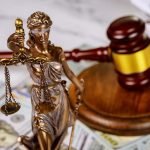 Gavel with books and scales on law office working law document