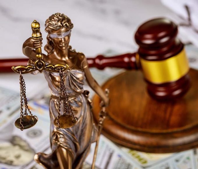 Gavel with books and scales on law office working law document