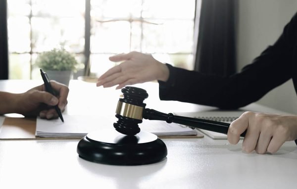 business people and lawyers discussing contract papers sitting at the table. Concepts of law, advice, legal services